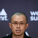 Chenpgeng Zhao staring to the side in front of a wall reading "web summit."